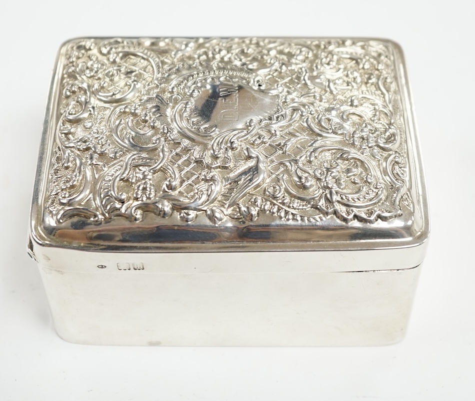 An Edwardian silver trinket box, with repousse hinged cover, William Comyns, London, 1907, 11cm. Condition - poor to fair